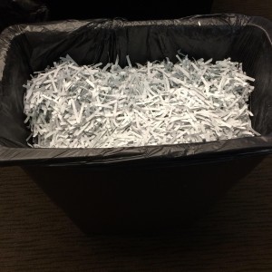 Trashcan with shredded documents.